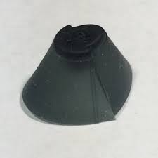 A small, dark gray SureFit (SF) Plus dome with a cone shape and flat circular top rests on a white surface.